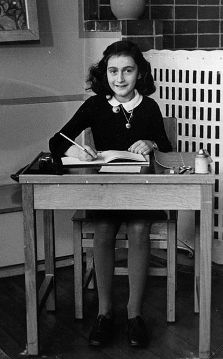 Anne Frank sitting in school desk