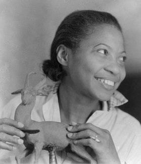 Photo of Augusta Savage holding a small sculpture