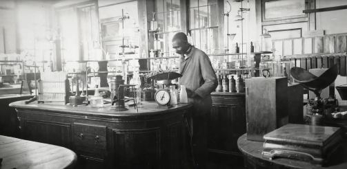 Carver standing at lab workbench