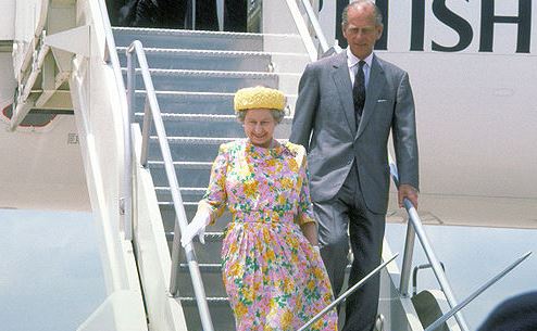 The queen and Prince Philip leaving an airplane