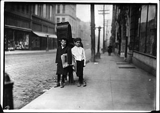 Two Newsies standing on the street