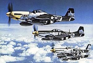 North American P-51 Mustangs flying in a row