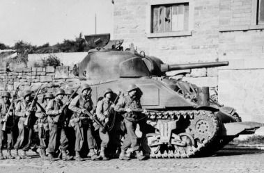 Sherman Tank with soldiers walking