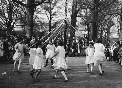 Children running around May Day Pole