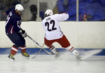 Hockey players going after puck