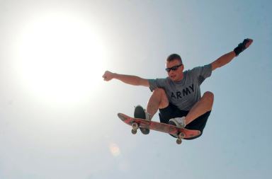 Skateboarder doing trick in the air after jump