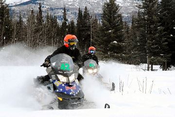 Snowmobile racers in the mountains