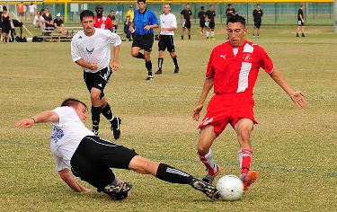 Soccer player slide tackling