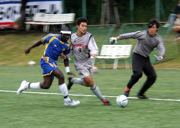 Soccer players going for the ball