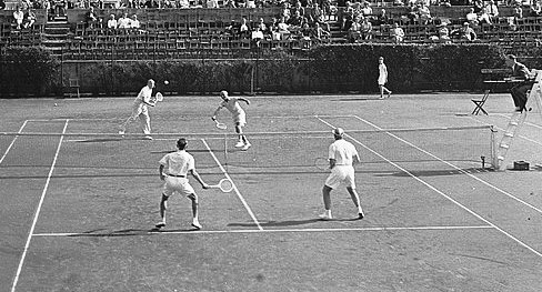 Players on tennis court playing doubles